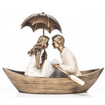 Rainy Day Couple in Boat Holding Brolly